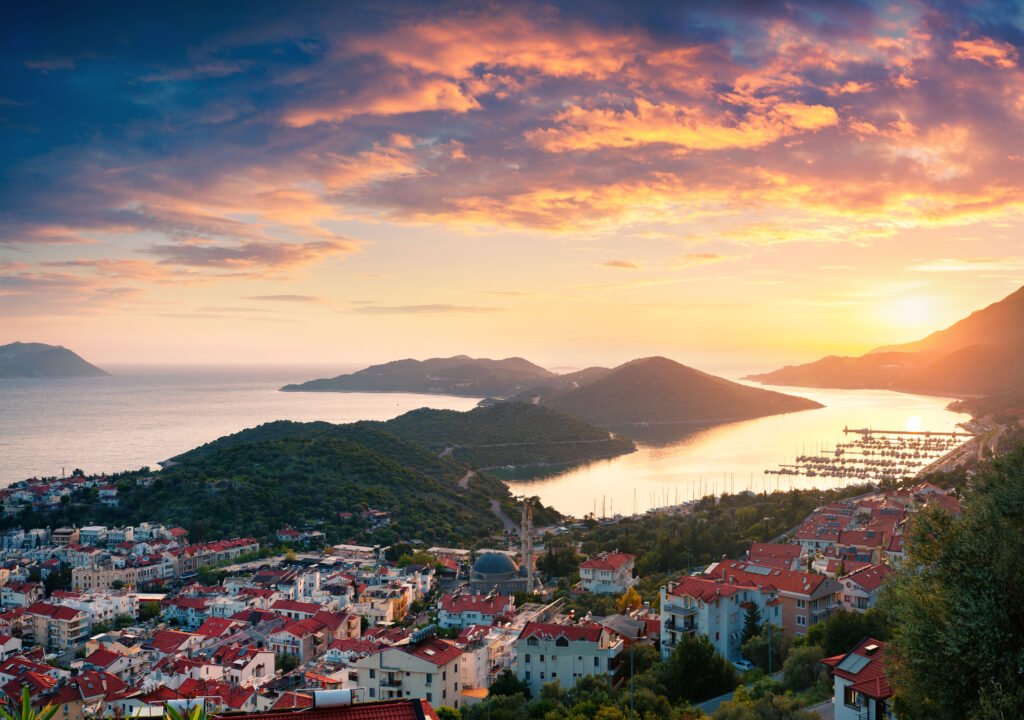 View from the bird's eye of the Kas city, district of Antalya Province of Turkey, Asia. Colorful spring sunset in small Mediterranean yachting and tourist town. Artistic style post processed photo.